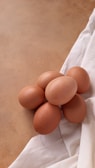 a pile of eggs sitting on top of a white cloth