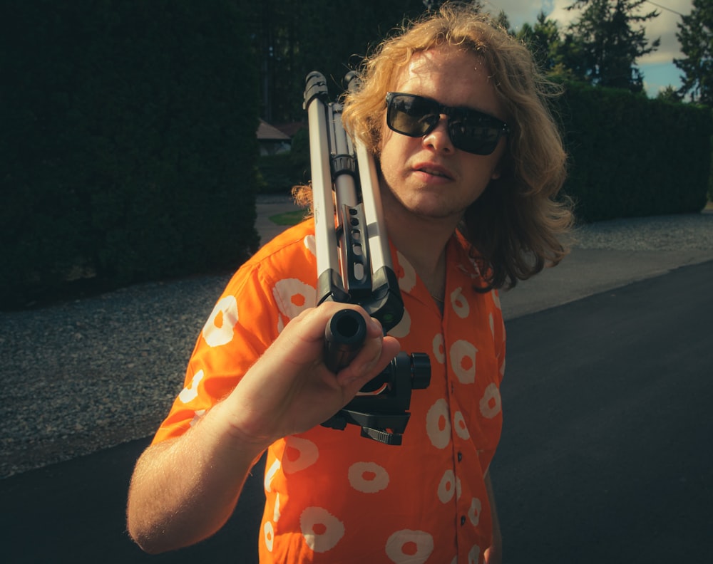 a man holding a pair of guns in his hands