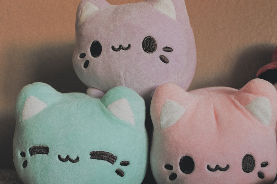 A row of stuffed animals sitting next to each other, representing a bulk custom plush production run priced by quantity