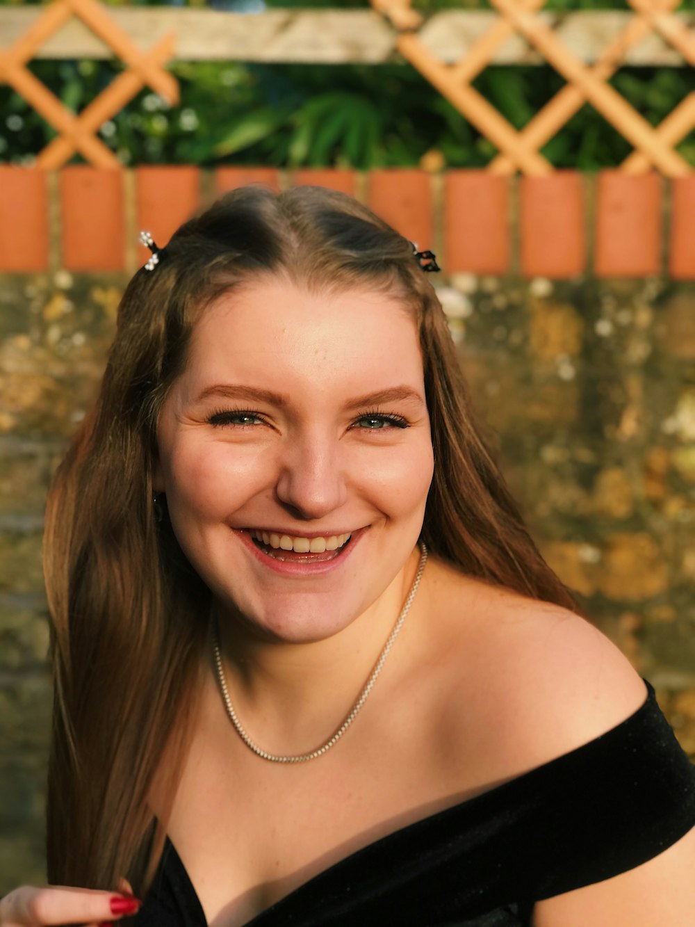 a woman with long hair smiling at the camera