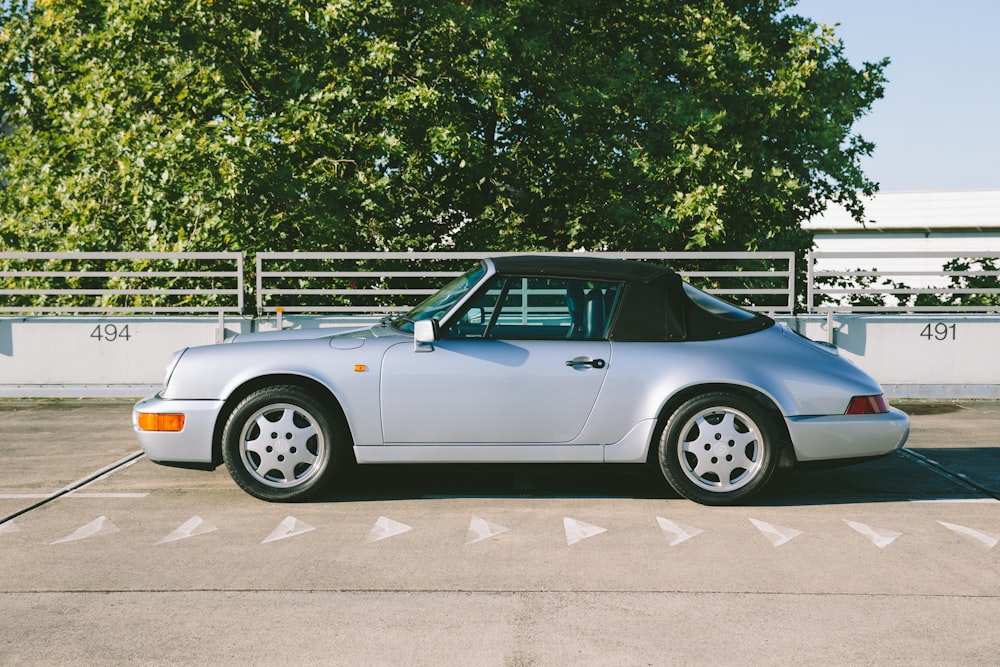 a silver sports car parked in a parking lot