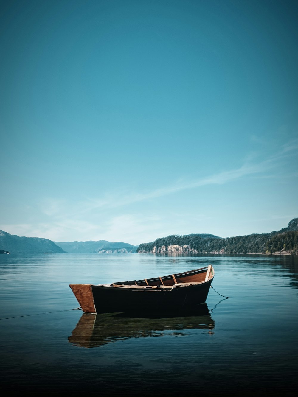 a small boat floating on top of a lake