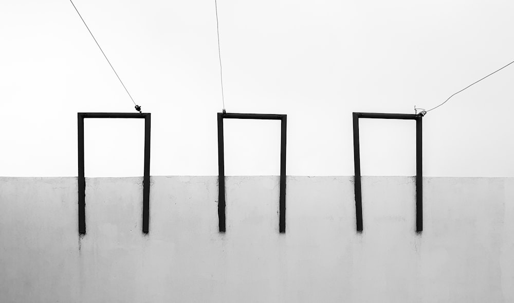 a black and white photo of three rectangular poles