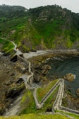 a scenic view of a rocky coastline with steps leading to the water