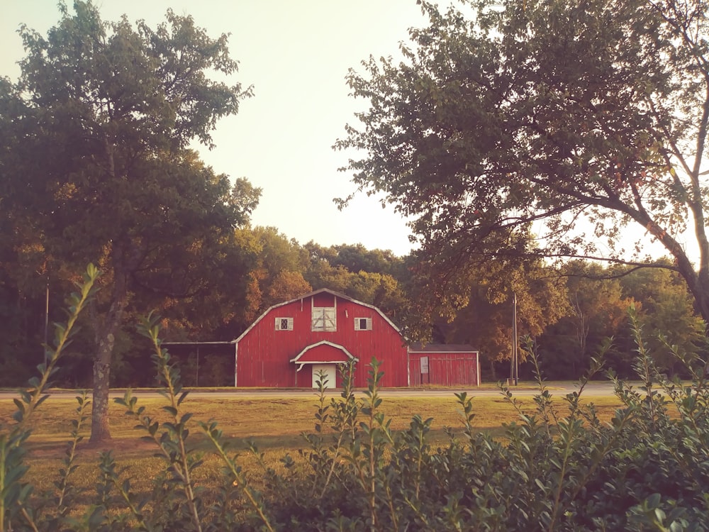 a red barn in the middle of a field