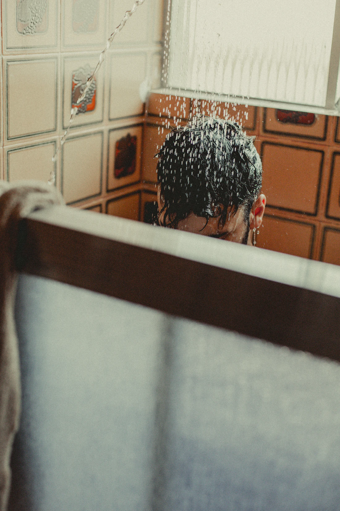 Person reflecting in a mirror while experiencing appearance-related concerns
