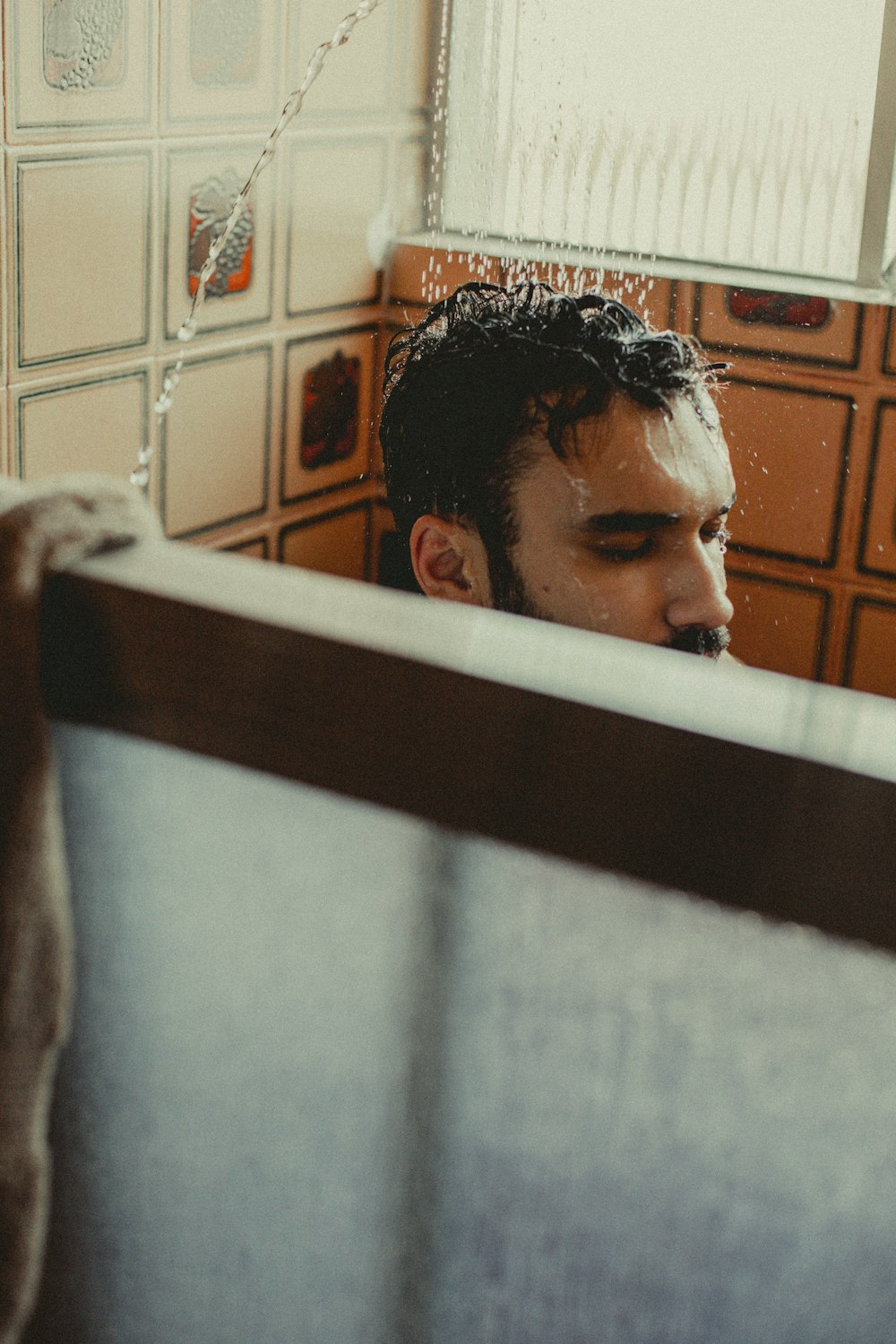 a man sitting in a bathtub in a bathroom