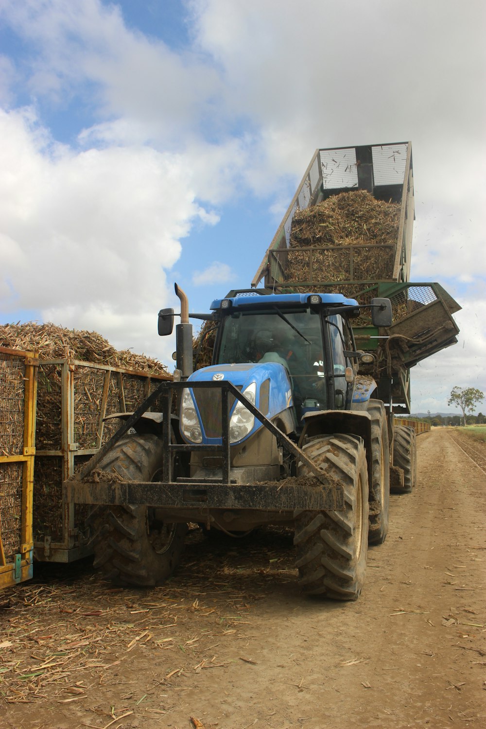 a large truck with a load of hay on the back of it