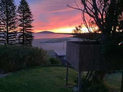 A stunning beachfront property at sunset.