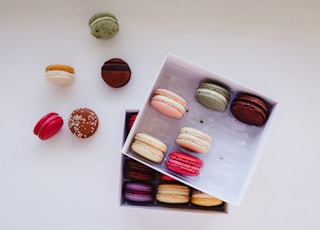 a box of assorted macaroons sitting on a table