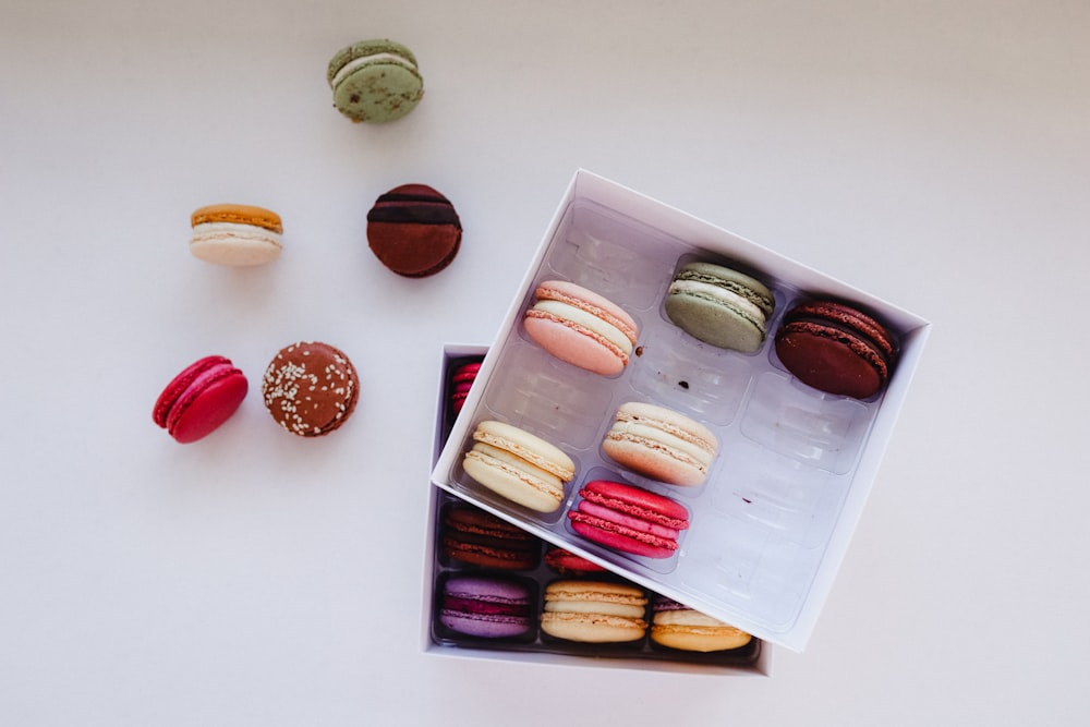 a box of assorted macaroons sitting on a table