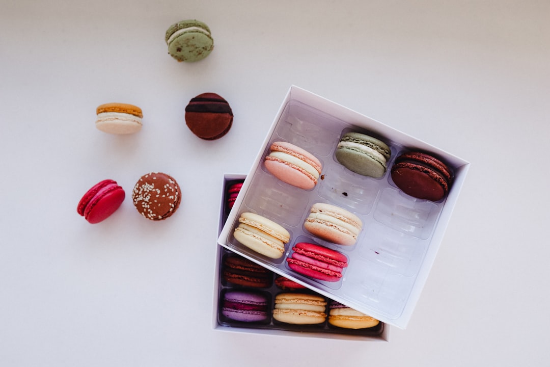 a box of assorted macaroons sitting on a table,