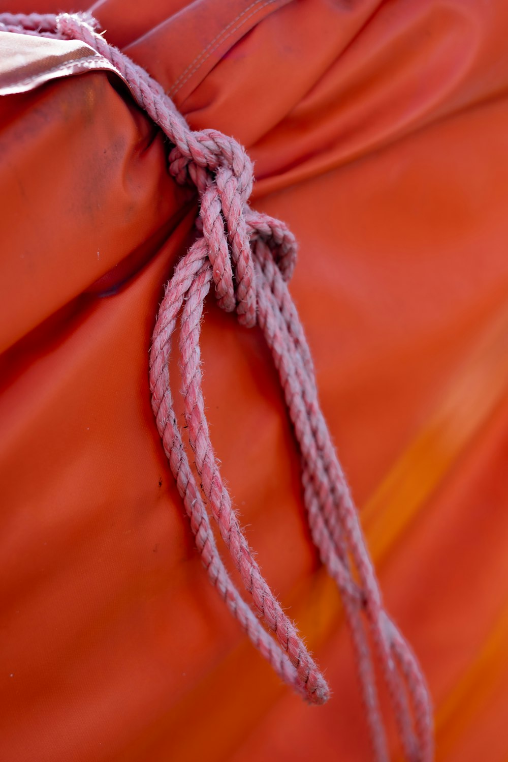 a knot is tied to a red cloth