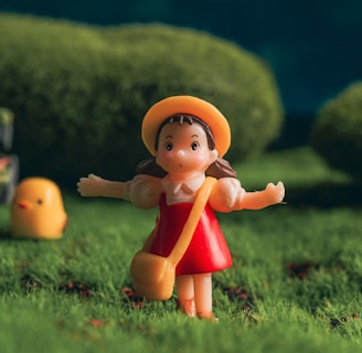 a little girl is standing in the grass