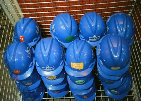 a bunch of blue helmets sitting on top of a metal rack