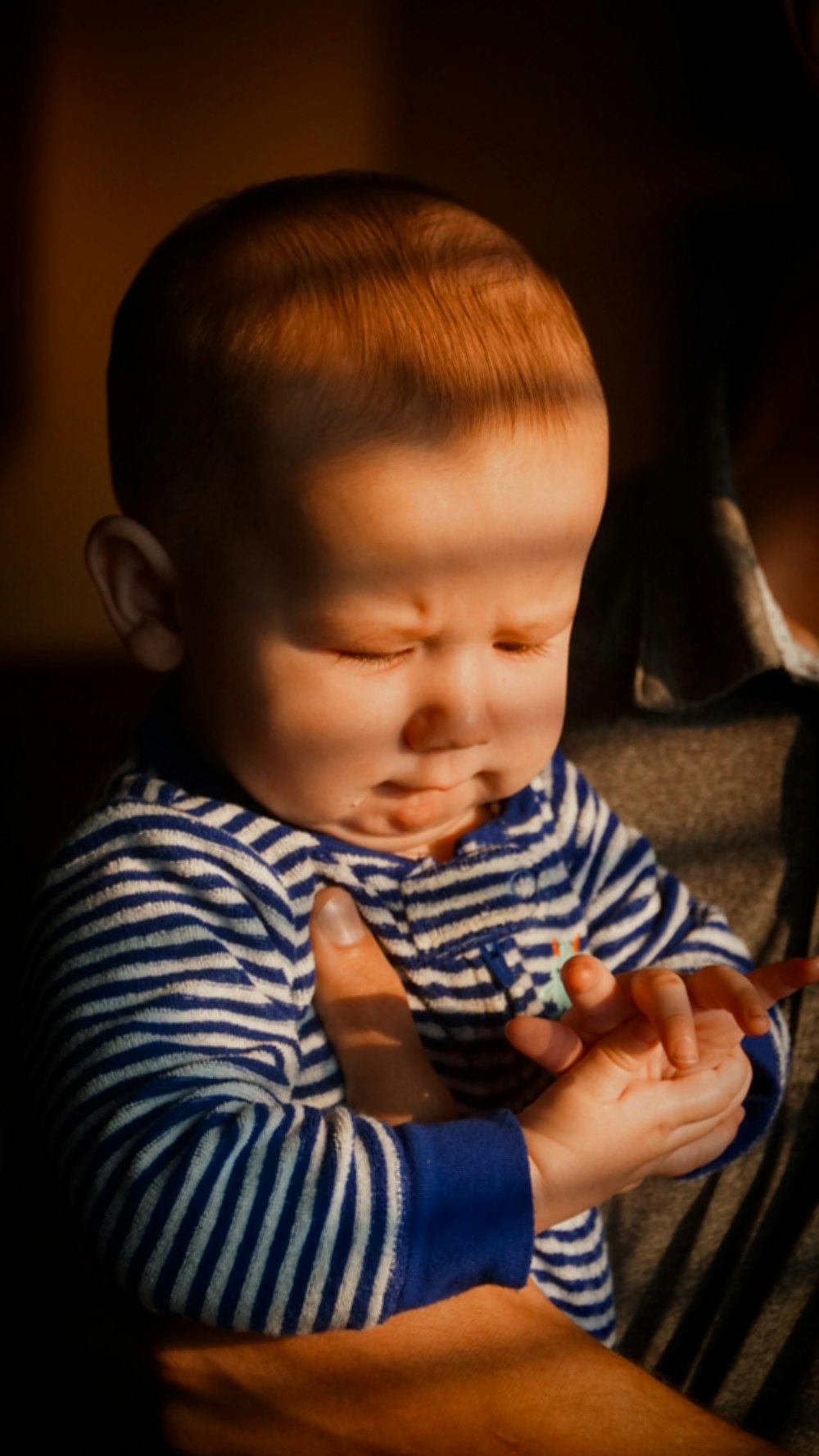 a man holding a baby in his arms