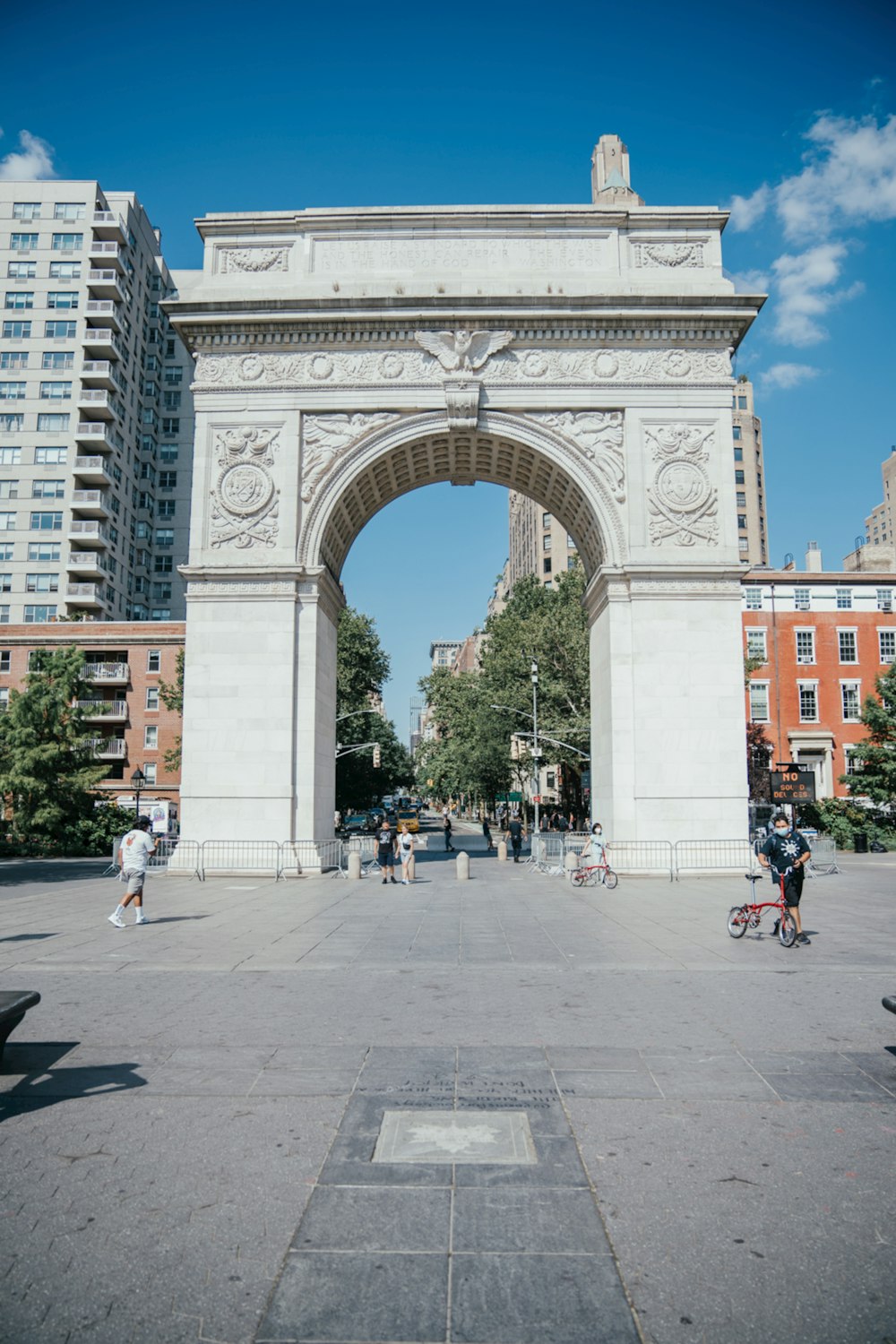 a large white arch in the middle of a city