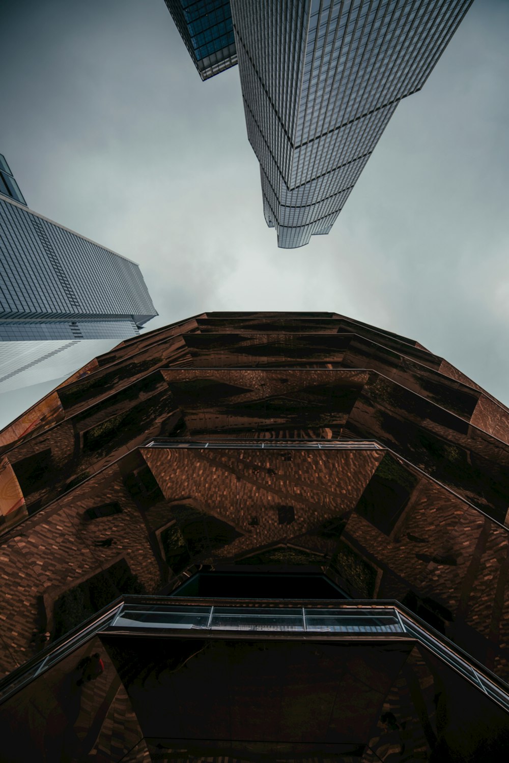 looking up at two skyscrapers from the ground