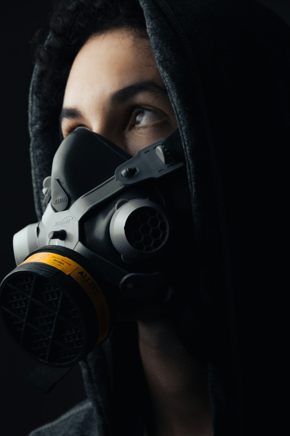 a person wearing a gas mask and a hood