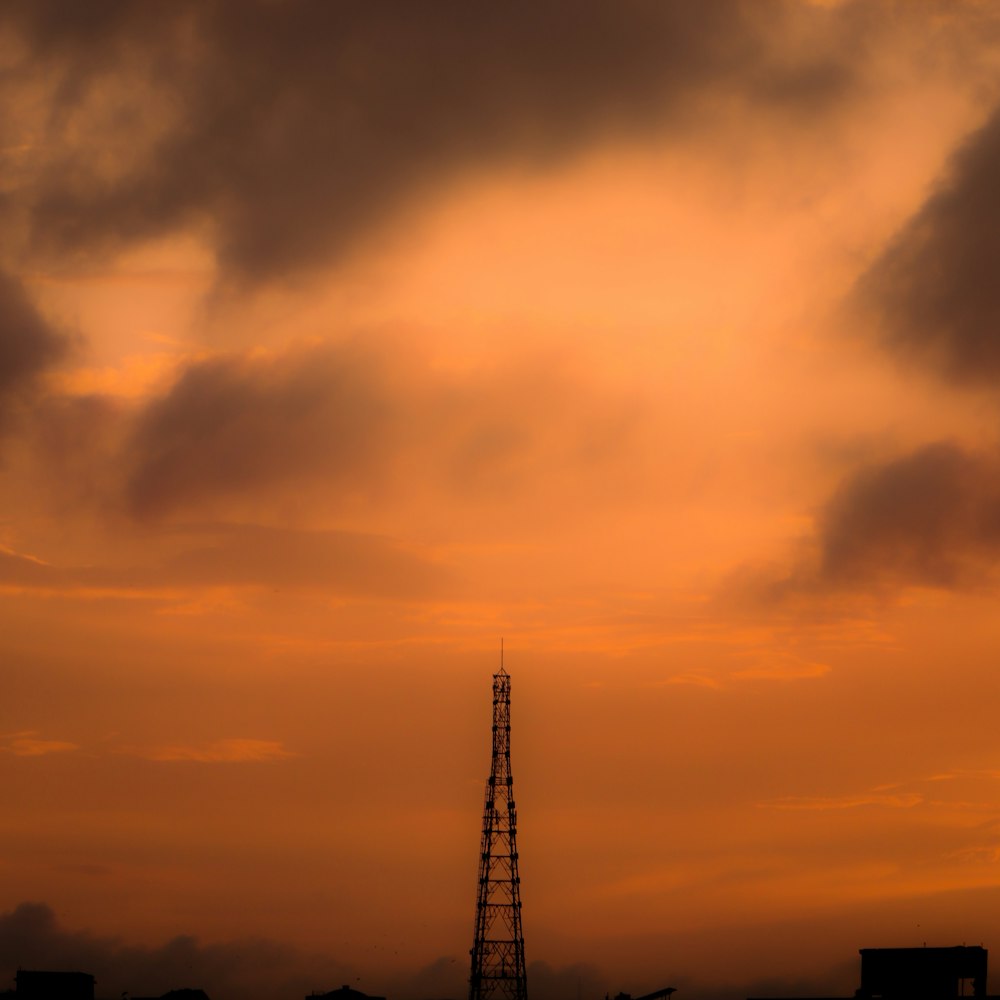 a very tall tower under a cloudy sky