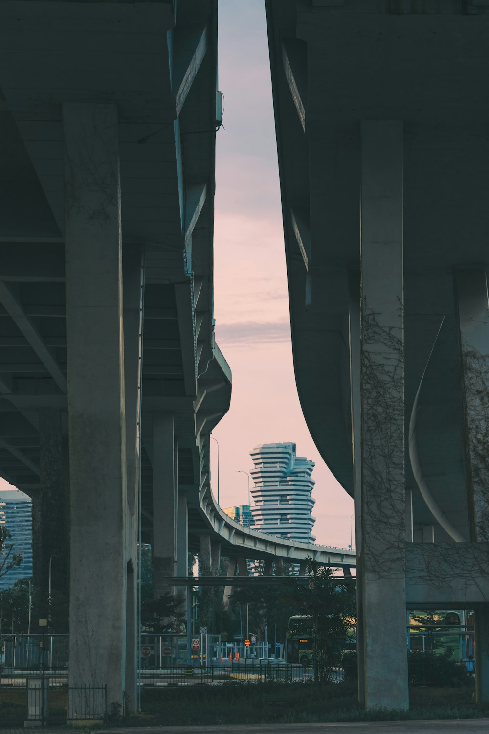 a view of a bridge with a tall building in the background