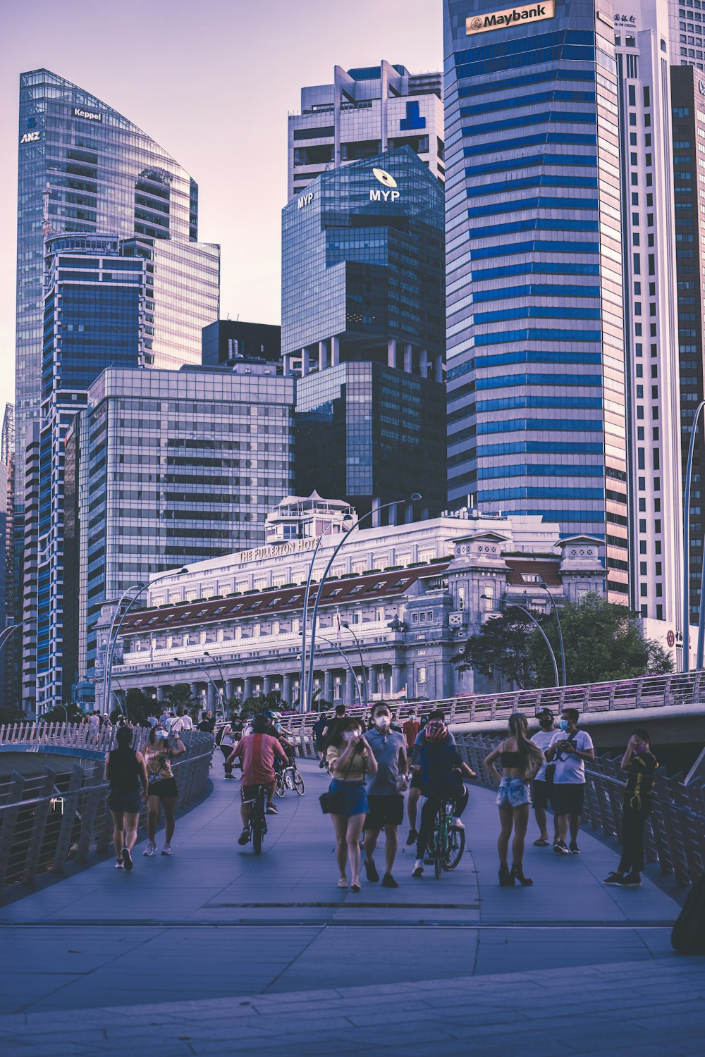 a group of people walking across a bridge