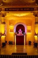 Himneet Beats in a vibrant live bhajan performance on a temple stage bathed in saffron lighting.