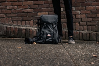 a bag of luggage sitting on the side of a building