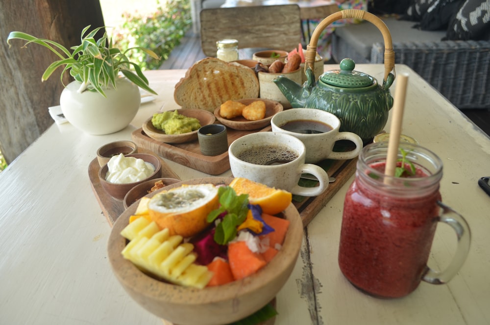 a wooden tray topped with bowls of food