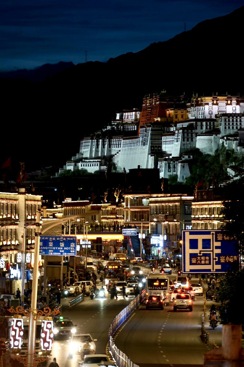 a night view of a city with a mountain in the background