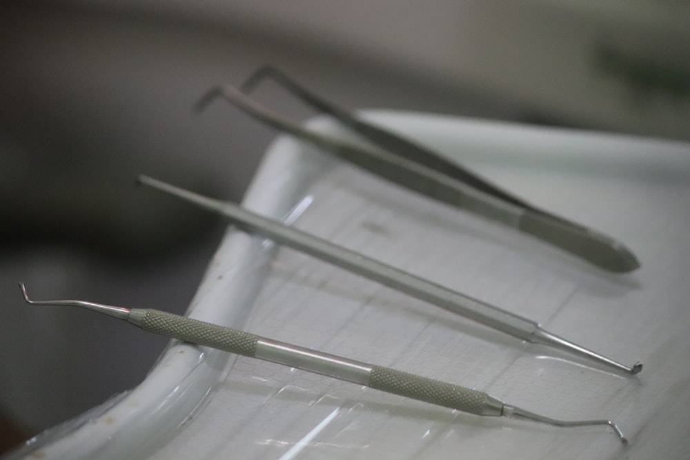 a row of dental instruments sitting on top of a sink