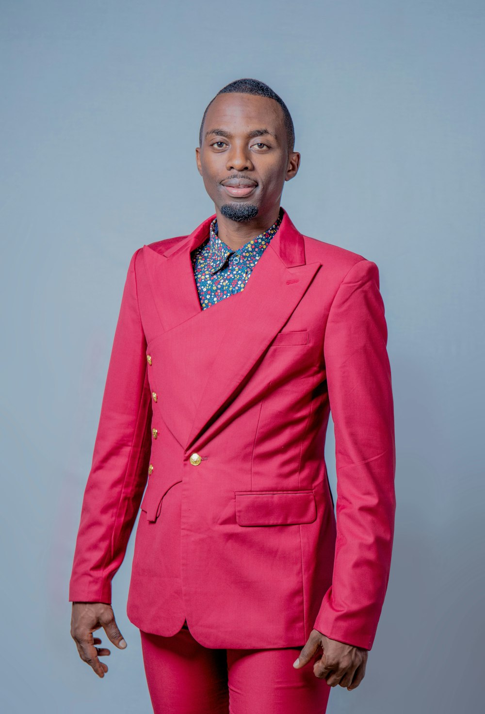 a man in a pink suit posing for a picture