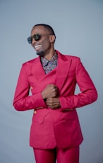a man in a pink suit and sunglasses