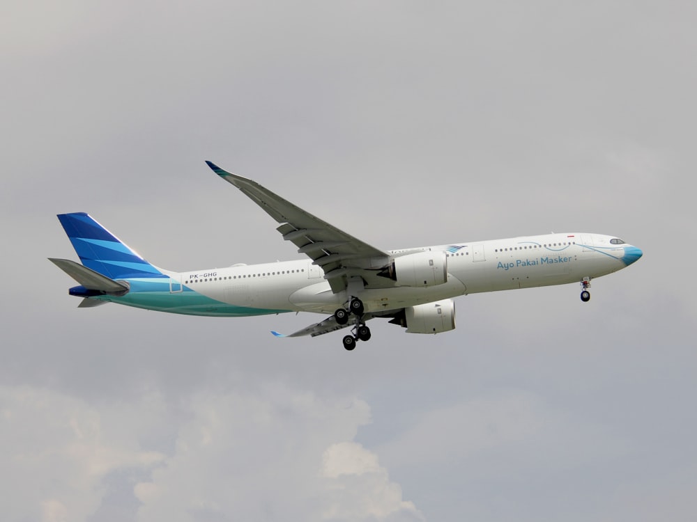 a large jetliner flying through a cloudy sky