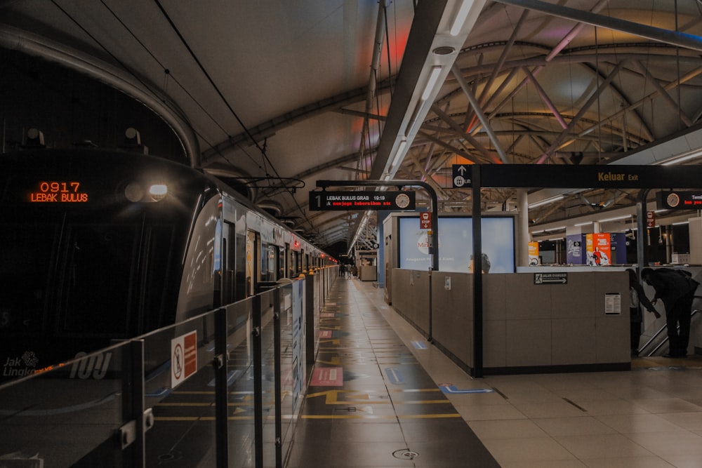 a train pulling into a train station next to a platform