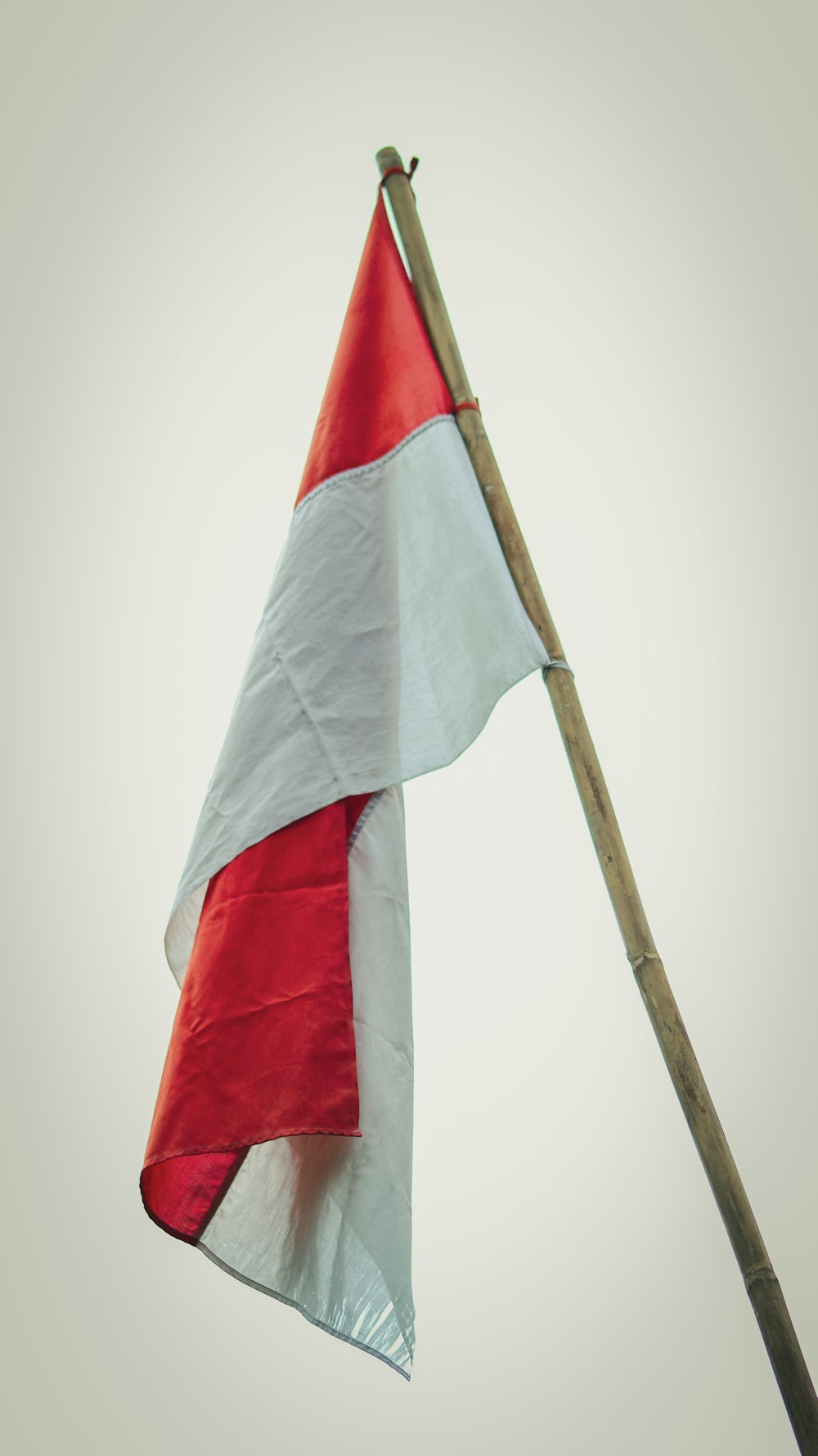 a red white and blue flag flying in the sky