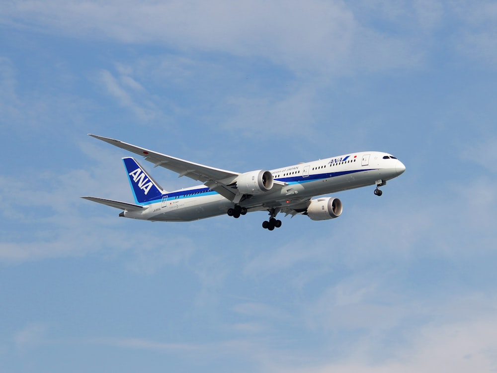 a large passenger jet flying through a blue sky