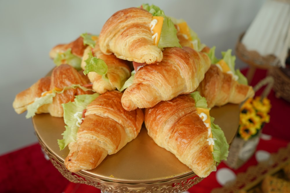 a pile of croissants sitting on top of a plate