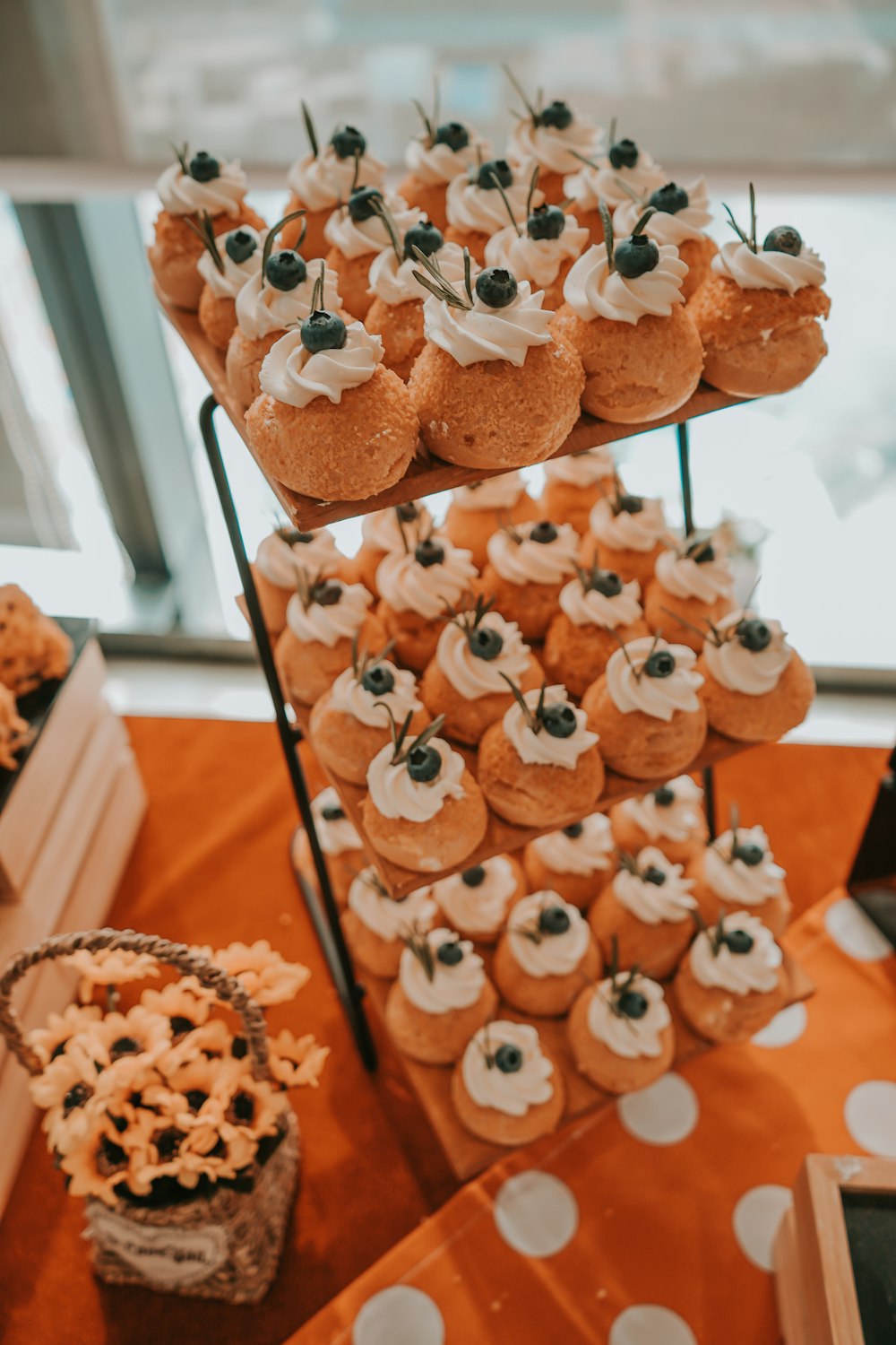 a table topped with lots of cupcakes covered in frosting