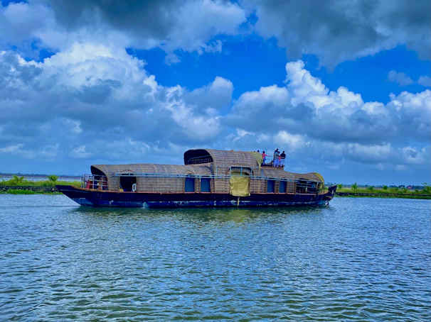 Guests enjoying a peaceful morning tea on the veranda of a houseboat surrounded by calm waters.