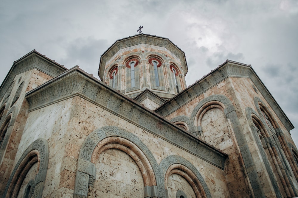 an old church with a steeple and a cross on top