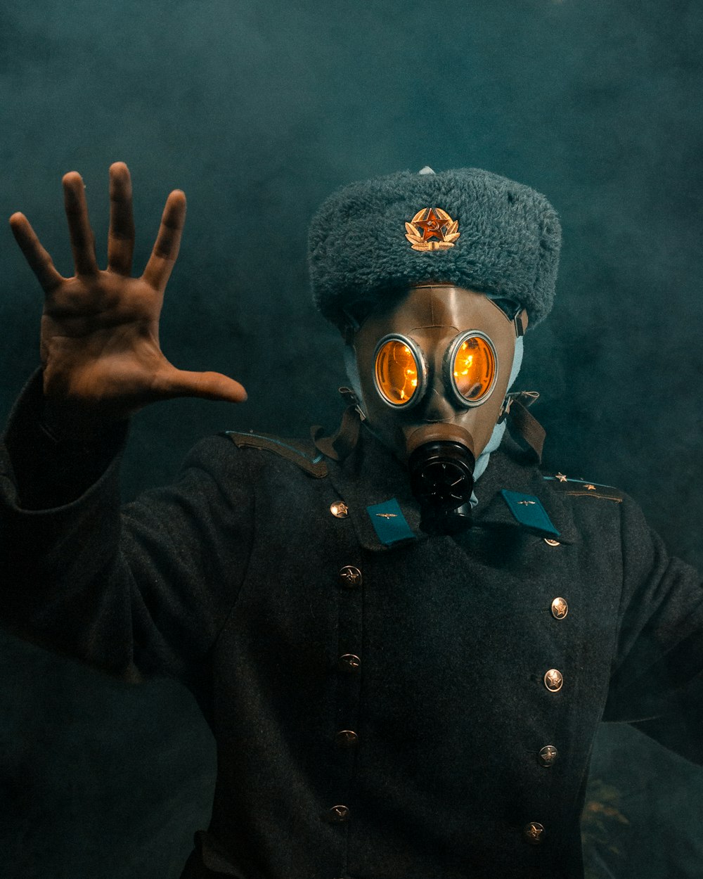 a man wearing a gas mask and a hat