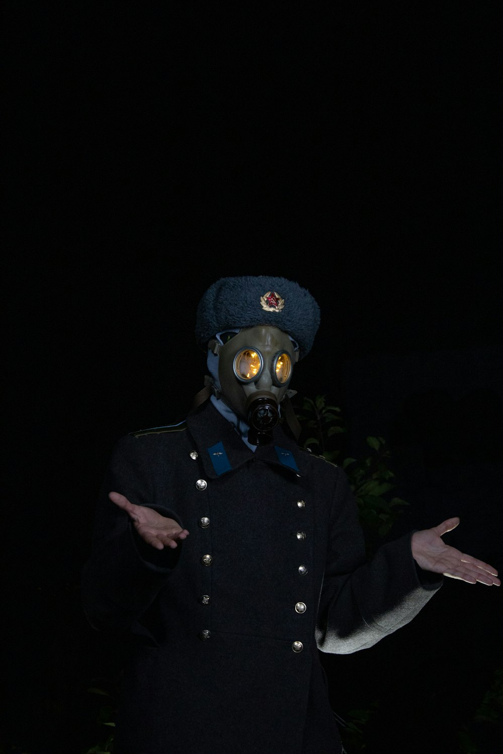 a man wearing a gas mask in the dark