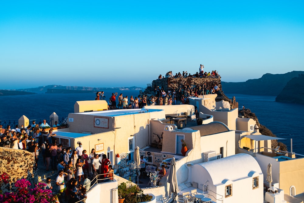 a group of people standing on top of a building