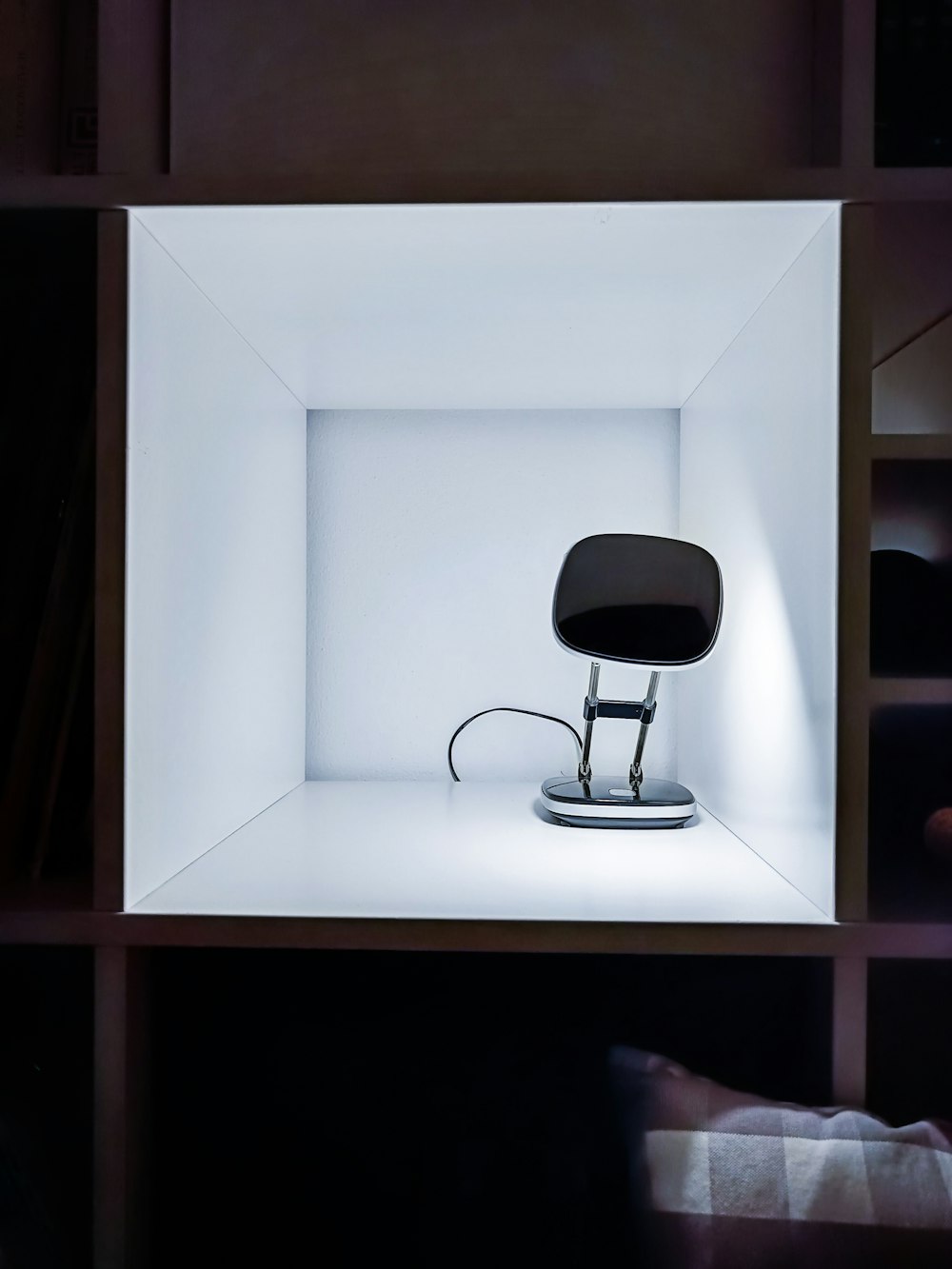 a black chair sitting in a white box