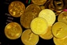 a pile of gold bitcoins sitting on top of each other