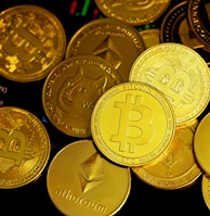 a pile of gold bitcoins sitting on top of each other