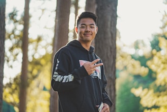 a man standing in a forest holding a frisbee