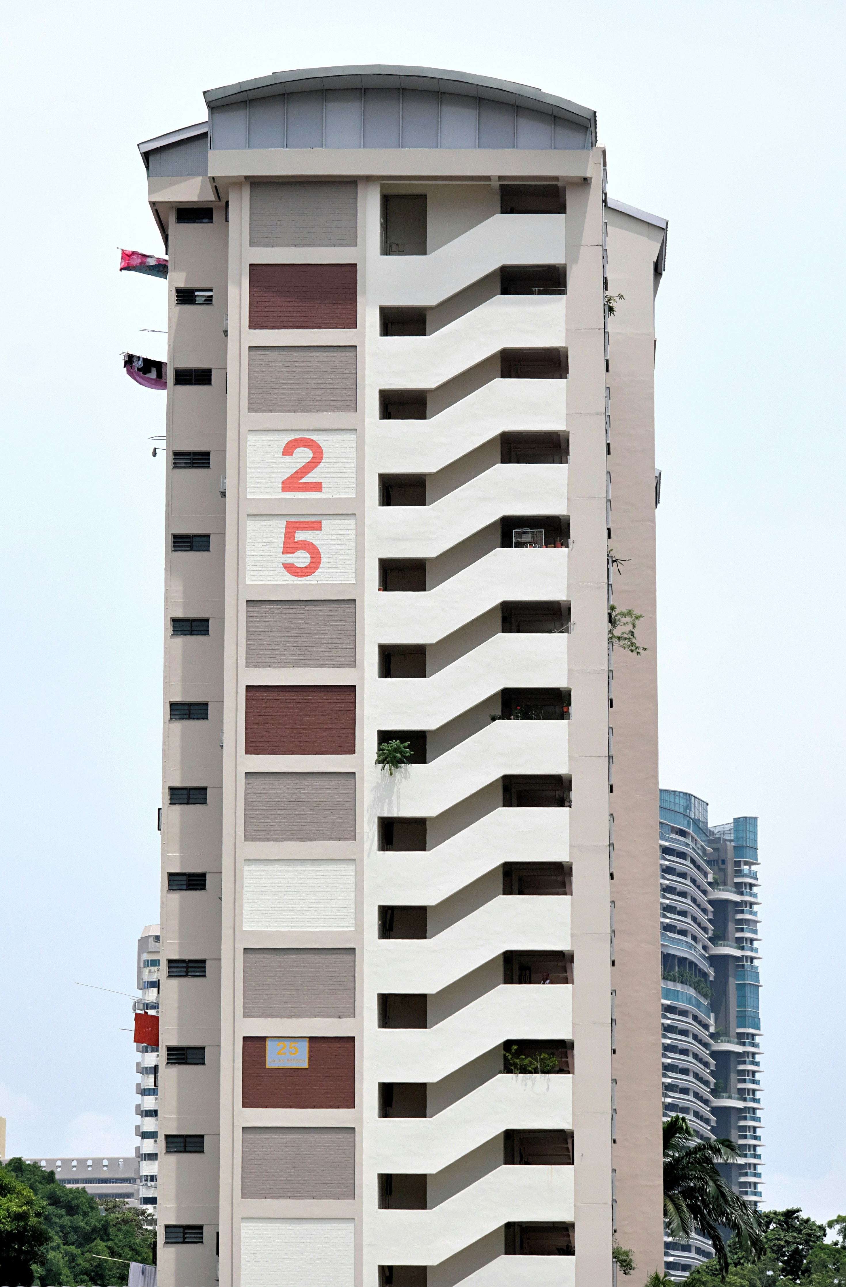 a tall white building with a clock on the side of it
