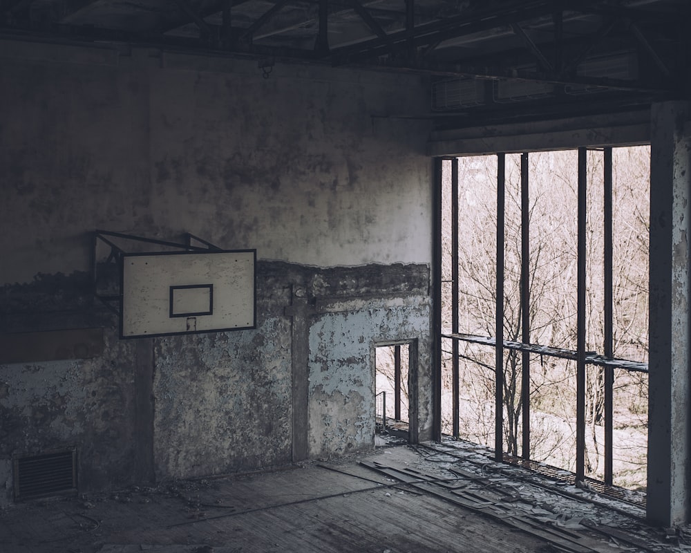 a basketball court in a run down building